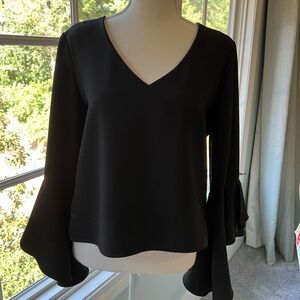 Perfect for a cocktail party! Black bell sleeve blouse.
